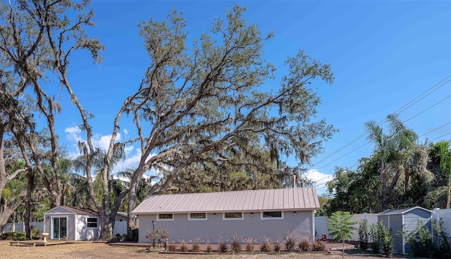 18101 Boy Scout Rd, Odessa, FL 33556 - view of side of home featuring stucco siding and metal roof