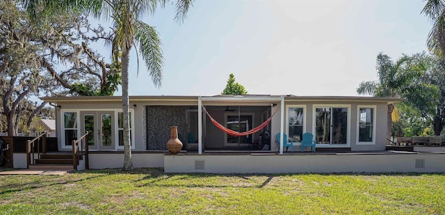 18101 Boy Scout Rd, Odessa, FL 33556 - back of property featuring a sunroom, a yard, and french doors