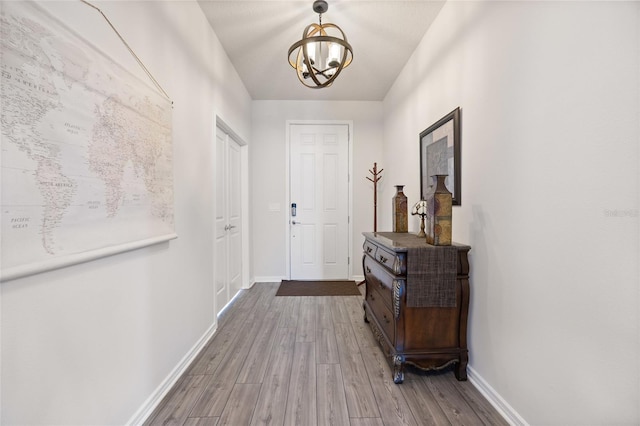 9478 SW 52nd Loop, Ocala, FL 34481 - entryway with a chandelier, wood finished floors, and baseboards