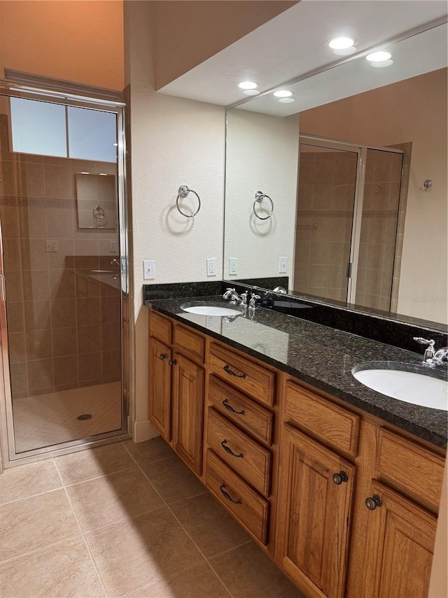 1848 NW 34th St Unit 23, Gainesville, FL 32605 - bathroom with double vanity, a stall shower, tile patterned floors, and recessed lighting