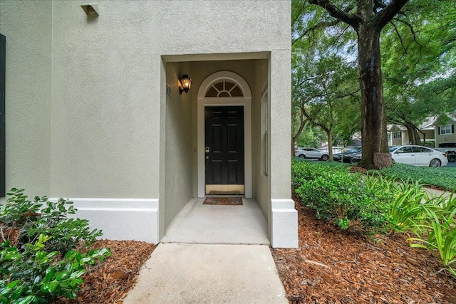10000 SW 52nd Ave Unit 120, Gainesville, FL 32608 - doorway to property with stucco siding
