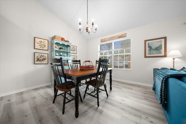 10000 SW 52nd Ave Unit 120, Gainesville, FL 32608 - dining space with a chandelier, light wood finished floors, baseboards, and vaulted ceiling