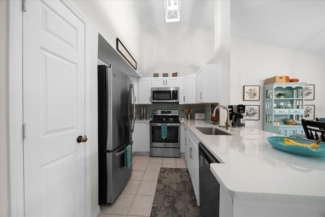 10000 SW 52nd Ave Unit 120, Gainesville, FL 32608 - kitchen featuring appliances with stainless steel finishes, a sink, a peninsula, light countertops, and light tile patterned floors