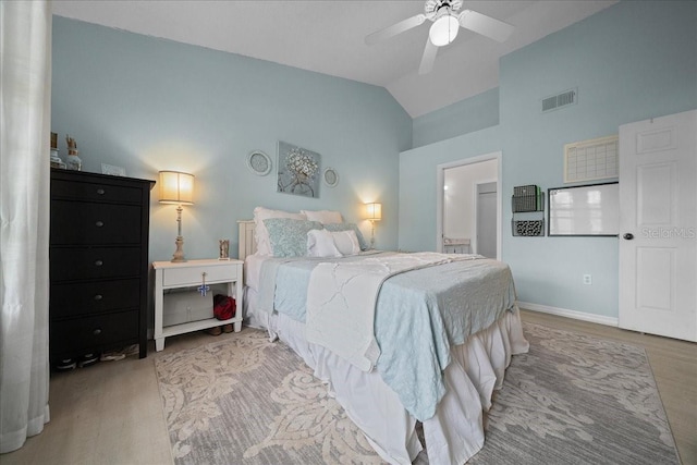 10000 SW 52nd Ave Unit 120, Gainesville, FL 32608 - bedroom with wood finished floors, baseboards, connected bathroom, high vaulted ceiling, and a ceiling fan