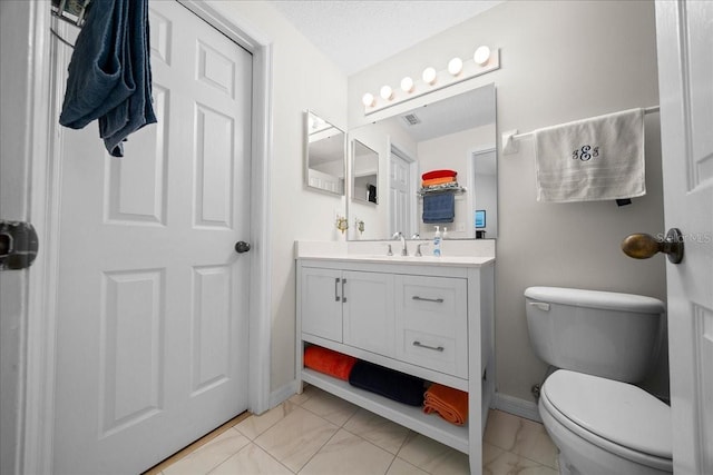 10000 SW 52nd Ave Unit 120, Gainesville, FL 32608 - bathroom featuring marble finish floors, toilet, vanity, and baseboards
