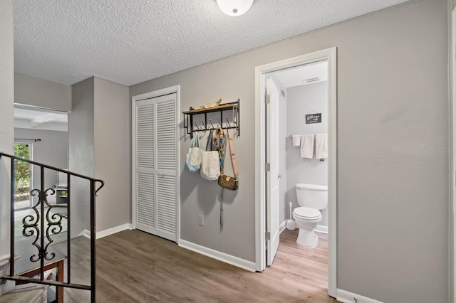 507 NW 39th Rd Unit 154, Gainesville, FL 32607 - hallway featuring wood finished floors, a textured ceiling, and baseboards