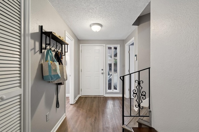 507 NW 39th Rd Unit 154, Gainesville, FL 32607 - entryway with a textured ceiling, a textured wall, wood finished floors, and baseboards