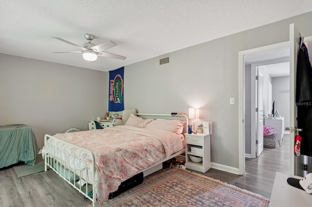 507 NW 39th Rd Unit 154, Gainesville, FL 32607 - bedroom featuring wood finished floors, a textured ceiling, a ceiling fan, and baseboards