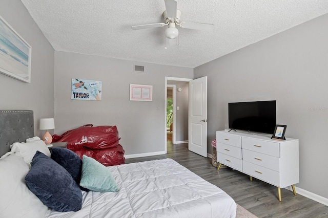 507 NW 39th Rd Unit 154, Gainesville, FL 32607 - bedroom featuring wood finished floors, a textured ceiling, baseboards, and ceiling fan