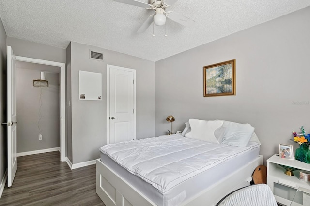 507 NW 39th Rd Unit 154, Gainesville, FL 32607 - bedroom with dark wood-style floors, a textured ceiling, baseboards, and a ceiling fan