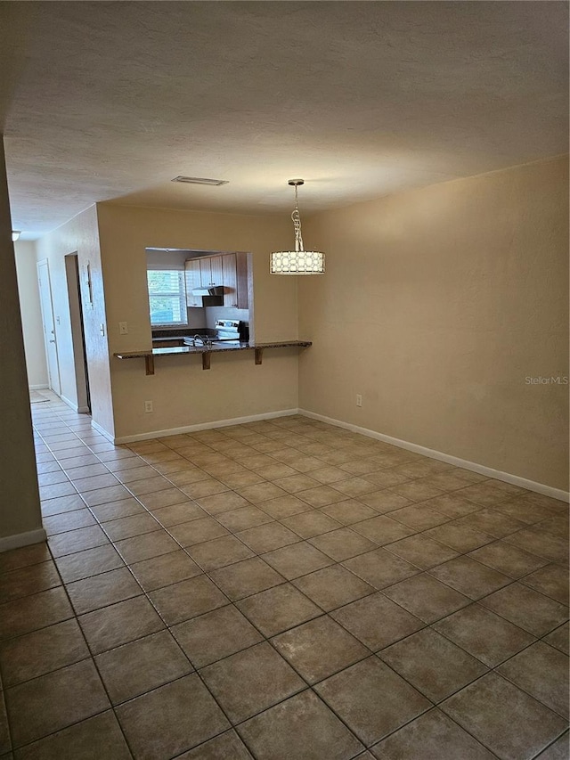 4007 SW 26th Ter Unit B, Gainesville, FL 32608 - spare room with dark tile patterned floors and baseboards