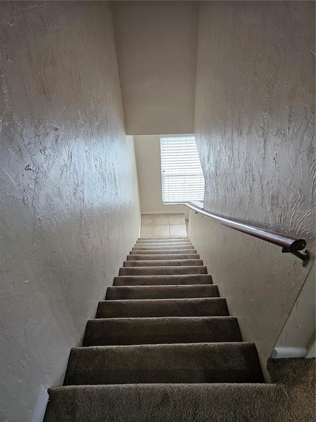 4007 SW 26th Ter Unit B, Gainesville, FL 32608 - staircase featuring a textured wall