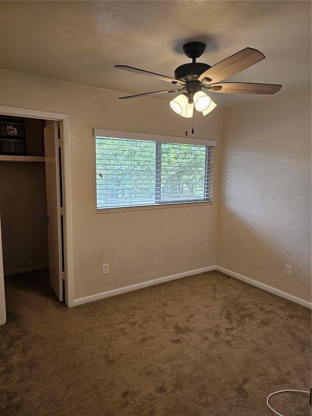 4007 SW 26th Ter Unit B, Gainesville, FL 32608 - unfurnished bedroom with carpet, a closet, baseboards, and a ceiling fan