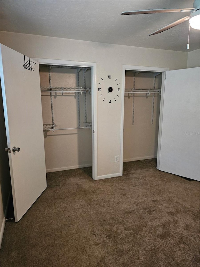 4007 SW 26th Ter Unit B, Gainesville, FL 32608 - unfurnished bedroom with two closets, carpet floors, a ceiling fan, and baseboards