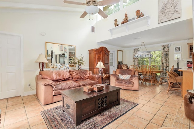 12832 SW 14th Ave, Newberry, FL 32669 - living room with light tile patterned flooring, a high ceiling, ceiling fan, and crown molding
