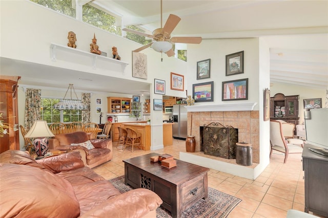 12832 SW 14th Ave, Newberry, FL 32669 - living room with light tile patterned flooring, a ceiling fan, beam ceiling, a tile fireplace, and high vaulted ceiling