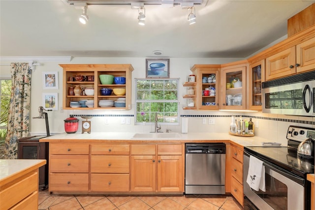 12832 SW 14th Ave, Newberry, FL 32669 - kitchen featuring appliances with stainless steel finishes, a sink, open shelves, and backsplash