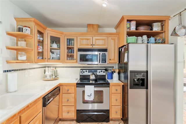 12832 SW 14th Ave, Newberry, FL 32669 - kitchen featuring stainless steel appliances, open shelves, light countertops, tasteful backsplash, and glass insert cabinets
