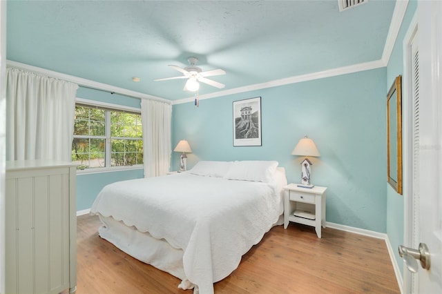 12832 SW 14th Ave, Newberry, FL 32669 - bedroom featuring baseboards, ornamental molding, wood finished floors, and ceiling fan