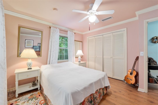 12832 SW 14th Ave, Newberry, FL 32669 - bedroom featuring wood finished floors, a closet, crown molding, a ceiling fan, and baseboards