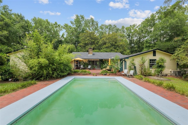 12832 SW 14th Ave, Newberry, FL 32669 - swimming pool featuring cooling unit and view of wooded area