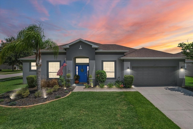 13365 Chesapeake Pl, Spring Hill, FL 34609 - view of front of home with an attached garage, stucco siding, driveway, and a yard