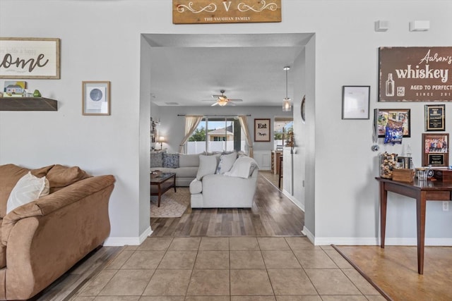 13365 Chesapeake Pl, Spring Hill, FL 34609 - tiled living room featuring a ceiling fan and baseboards