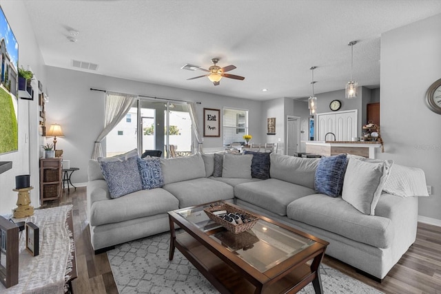 13365 Chesapeake Pl, Spring Hill, FL 34609 - living room with wood finished floors, ceiling fan, and baseboards
