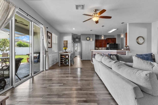 13365 Chesapeake Pl, Spring Hill, FL 34609 - living room featuring a ceiling fan and dark wood-style floors