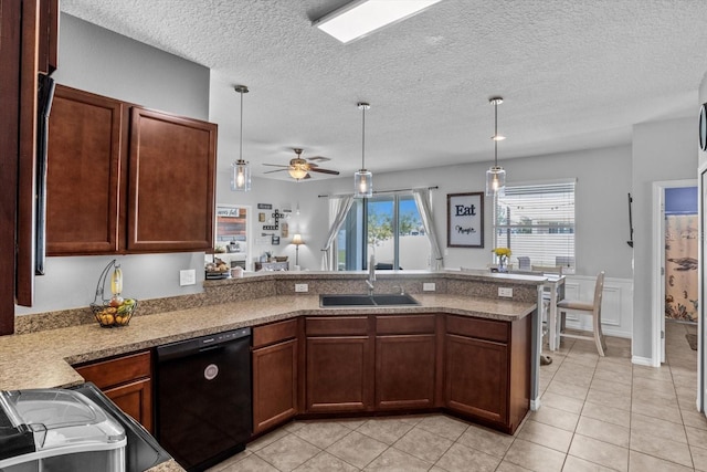 13365 Chesapeake Pl, Spring Hill, FL 34609 - kitchen featuring black dishwasher, a peninsula, a sink, a ceiling fan, and light tile patterned floors