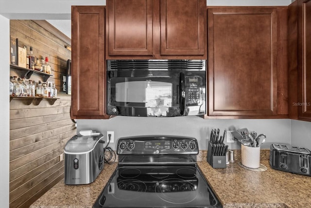 13365 Chesapeake Pl, Spring Hill, FL 34609 - kitchen with electric range oven, black microwave, and wooden walls