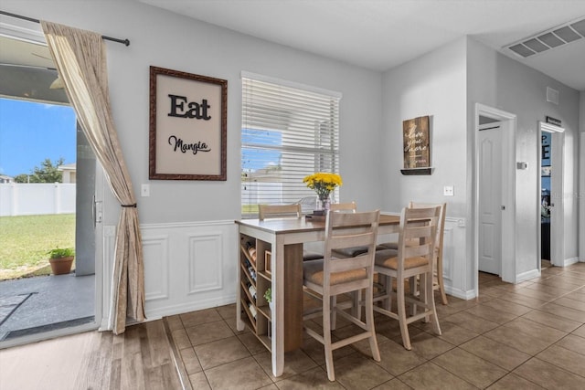 13365 Chesapeake Pl, Spring Hill, FL 34609 - tiled dining room featuring a wainscoted wall