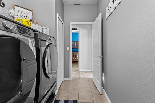 13365 Chesapeake Pl, Spring Hill, FL 34609 - laundry room with washing machine and clothes dryer, light tile patterned floors, and baseboards
