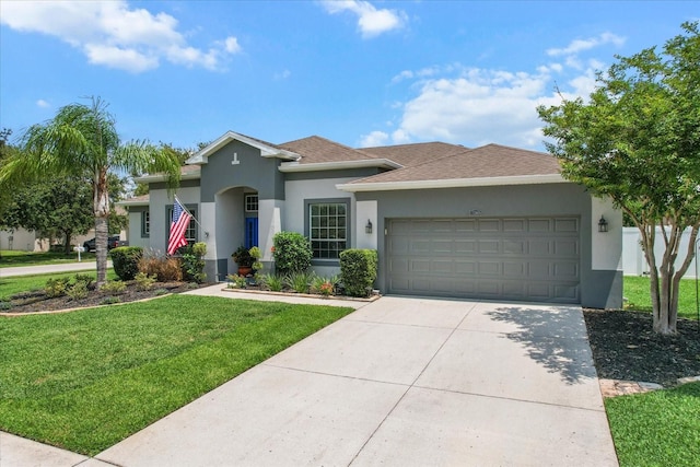 13365 Chesapeake Pl, Spring Hill, FL 34609 - view of front facade featuring an attached garage, a front lawn, stucco siding, concrete driveway, and roof with shingles