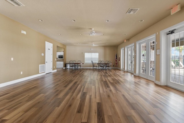 13365 Chesapeake Pl, Spring Hill, FL 34609 - unfurnished living room featuring wood finished floors, recessed lighting, baseboards, and healthy amount of natural light