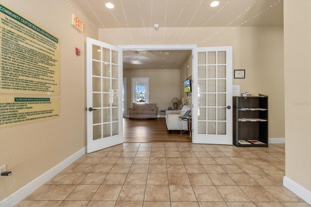 13365 Chesapeake Pl, Spring Hill, FL 34609 - corridor with french doors, light tile patterned floors, and baseboards