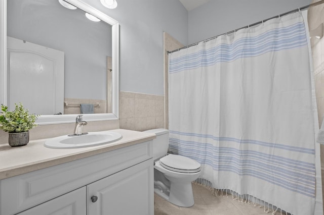 923 SW 85th Way, Gainesville, FL 32607 - full bath with toilet, tile walls, vanity, tile patterned floors, and wainscoting