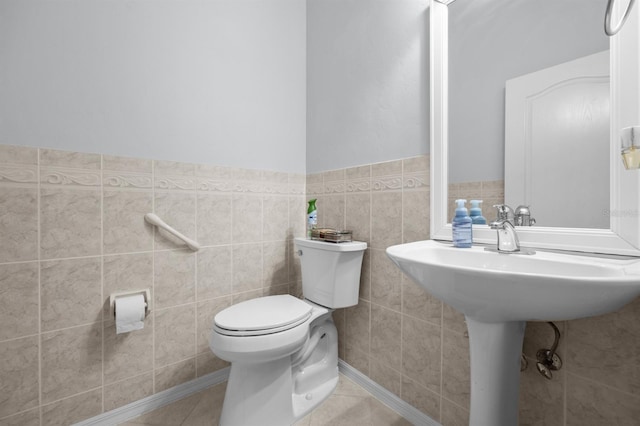923 SW 85th Way, Gainesville, FL 32607 - bathroom featuring toilet, tile walls, a wainscoted wall, and tile patterned floors