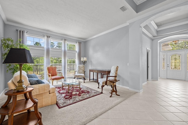 923 SW 85th Way, Gainesville, FL 32607 - living area featuring arched walkways, light tile patterned flooring, crown molding, and baseboards