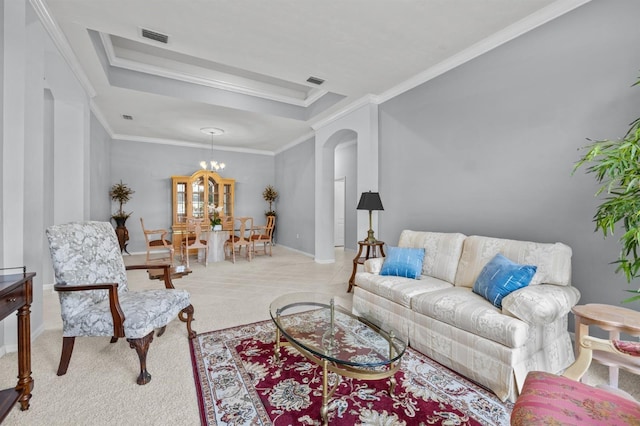 923 SW 85th Way, Gainesville, FL 32607 - living area with arched walkways, carpet floors, crown molding, a chandelier, and a raised ceiling