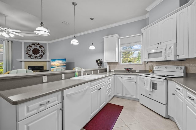 923 SW 85th Way, Gainesville, FL 32607 - kitchen featuring white appliances, a sink, ornamental molding, tasteful backsplash, and a peninsula