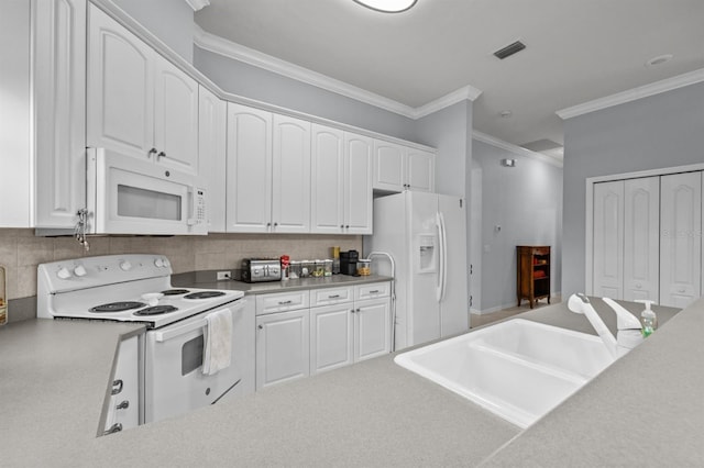 923 SW 85th Way, Gainesville, FL 32607 - kitchen with white appliances, crown molding, decorative backsplash, a sink, and white cabinets