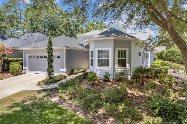 923 SW 85th Way, Gainesville, FL 32607 - view of front facade featuring a garage, driveway, and roof with shingles