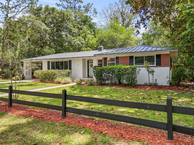 3941 SW 4th Pl, Gainesville, FL 32607 - single story home featuring a standing seam roof, metal roof, brick siding, and a chimney