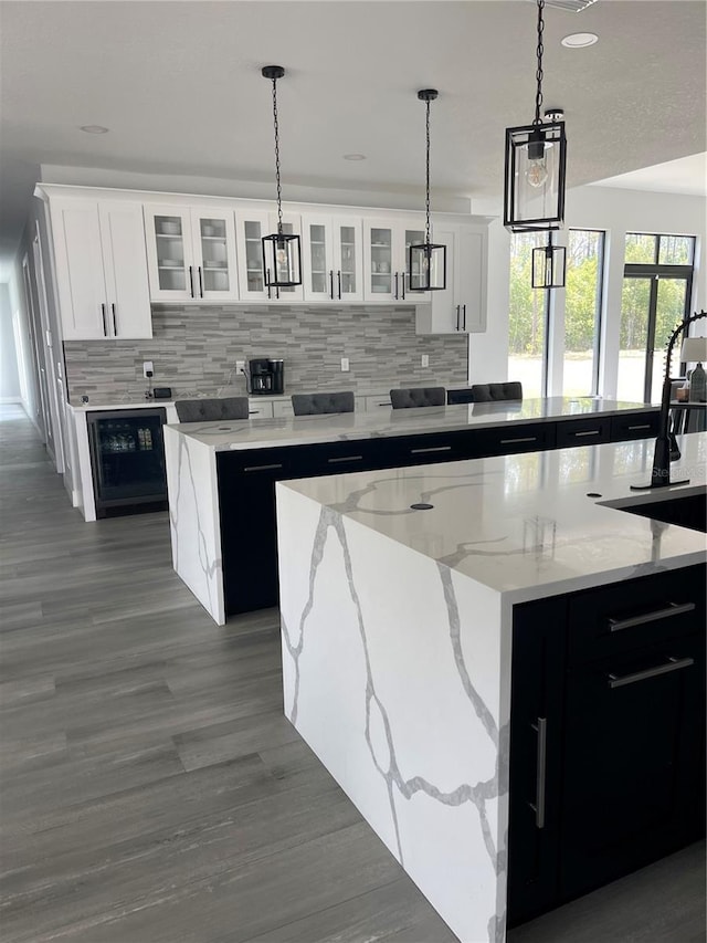 2518 Sunset Ln, Lutz, FL 33559 - kitchen featuring tasteful backsplash, decorative light fixtures, white cabinetry, a center island, and recessed lighting