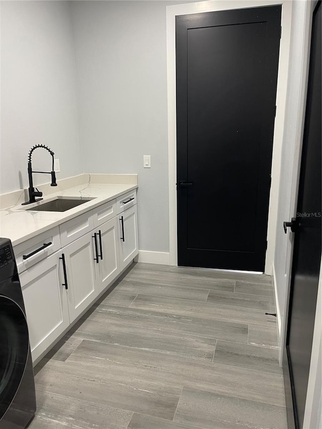 2518 Sunset Ln, Lutz, FL 33559 - washroom featuring washer / dryer, cabinet space, and light wood-type flooring