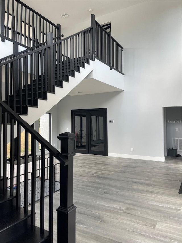 2518 Sunset Ln, Lutz, FL 33559 - stairs featuring a towering ceiling and wood finished floors