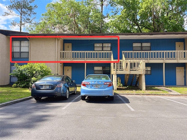 2811 SW Archer Rd Unit T164, Gainesville, FL 32608 - view of building exterior with uncovered parking and stairs