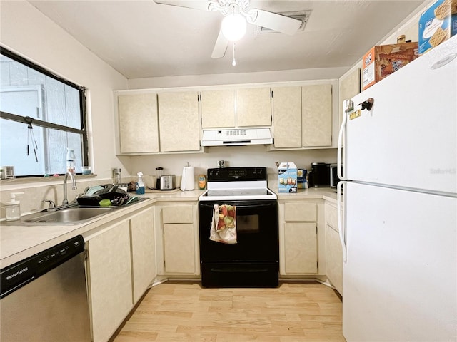 2811 SW Archer Rd Unit T164, Gainesville, FL 32608 - kitchen with freestanding refrigerator, range with electric cooktop, under cabinet range hood, dishwasher, and light wood-style flooring