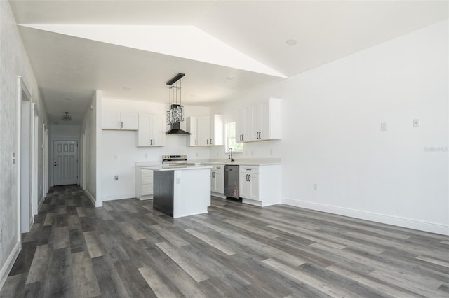 5670 NE 140th Ct, Williston, FL 32696 - kitchen featuring range hood, a kitchen island, stainless steel appliances, white cabinets, and lofted ceiling